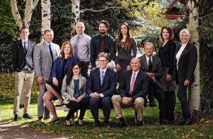 group image of the attorneys and litigation support staff of Tarlow Stonecipher Weamer & Kelly, PLLC posing outside