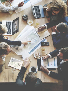people sitting around a conference table in a meeting