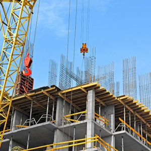 construction site scaffolding with large yellow crane