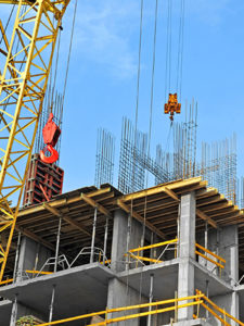 construction site scaffolding with large yellow crane